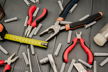 Tools such as pliers, screwdrivers, cutters, ratchet wrench, meter and dowels for maintenance work