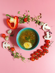 Culinary dishes made from natural products on a colored plate on a background with ingredients for cooking. Healthy eating concept. Top view.