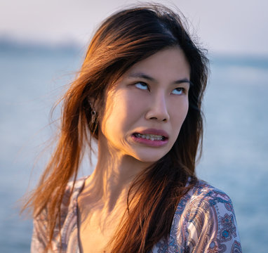 Asian Woman With Unhappy Face, Cute Asian Woman With Long Hair With Funny Upset Face Portrait.