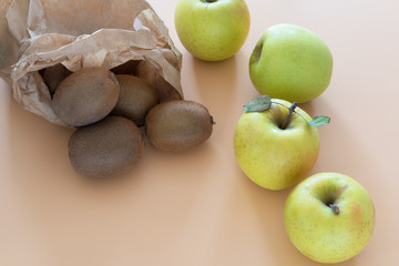 kiwi and apples on orange background