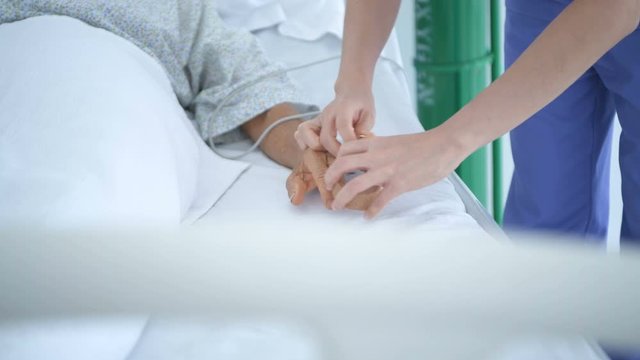Medical concepts. The nurse is wearing a pulse monitor for the patients in the hospital. 4k Resolution.