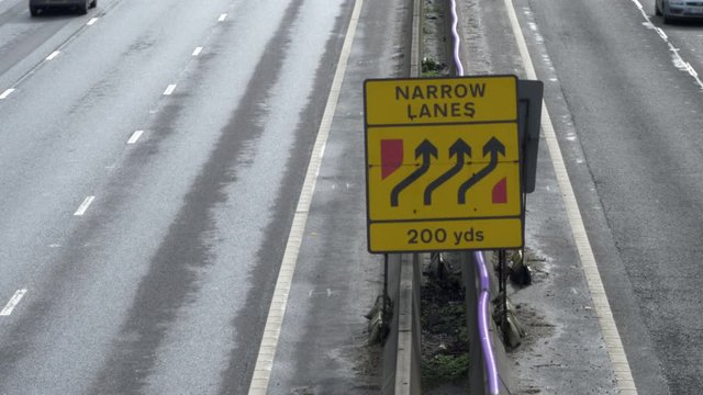 narrow lanes roadworks sign on uk motorway in england