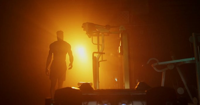 Man working out in dark gym