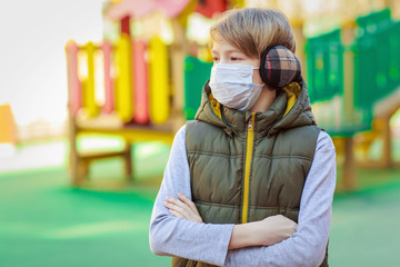 School boy wearing medical mask, outdoor
