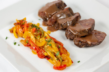 Veal shank with colored peppers