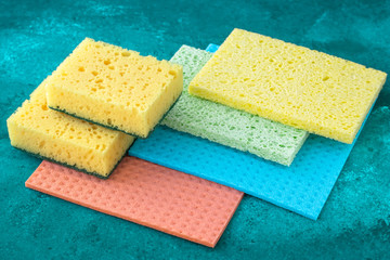 Kitchen dishcloth, cleanup concept, housework. Colorful kitchen sponges for cleaning close-up, housekeeping.