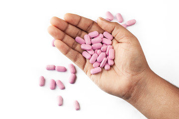 pills or caplet on human hand