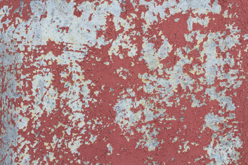 Old wooden plywood with peeling red paint. Close-up. Background. Texture.