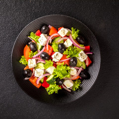Greek salad of fresh vegetables, olives and feta. Traditional Mediterranean food.