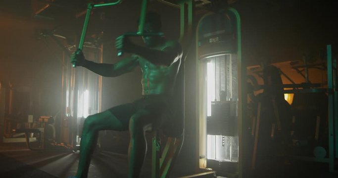 Man working out in dark gym