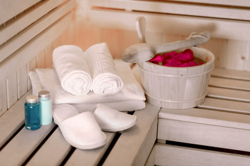 Sauna accessories on wooden shelves.