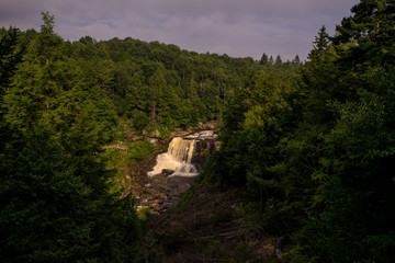 Fototapeta premium This s a distant view of the morning sun hitting Blackwater Falls in West Virginia.
