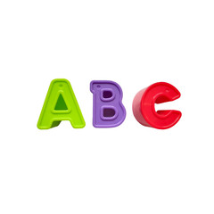 multi-colored plastic letters a, b, c are isolated on a white background. green, purple, red, toys, alphabet learning