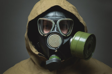 Man in gas mask close up on gray background.
