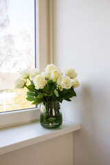 White roses in glass vase.