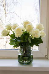 White roses in glass vase.