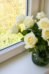 White roses in glass vase.