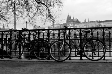 Fototapeta na wymiar Bicycles on the street with the Prague castle in the background - Czech Republic