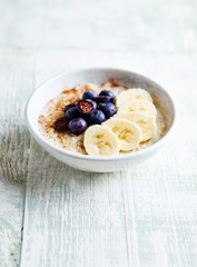 Oatmeal porridge with almond milk, banana, blueberries and cinnamon. Healthy homemade food