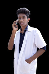 healthcare, hospital and medical concept - male doctor speaking on the smart phone, standing isolated over black background