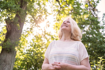 Obraz premium Woman walking in the park in summer day.