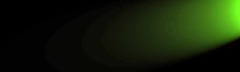 Green light shining from the side on a black background with a lot of space