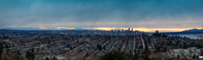 Fototapeta na wymiar Burnaby, Greater Vancouver, British Columbia, Canada . Beautiful Aerial Panoramic View of the city from the top of the hill during a colorful winter sunset.
