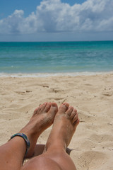 Feet close up with caribbean sea