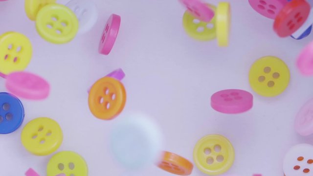 Buttons colorful couture falling. Many coloured buttons fall and run around. Color, fashion concept.