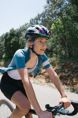 Female cyclist smiles happy on bike ride
