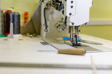 professional production sewing machine close-up, leather production, seamstress, tailor
