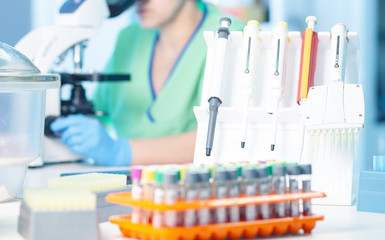 Female professional works with microscope in test lab. Blood samples of suspected cases of...