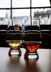 Flight of Scottish whisky, tasting glasses with variety of single malts or blended whiskey spirits on distillery tour in Scotland