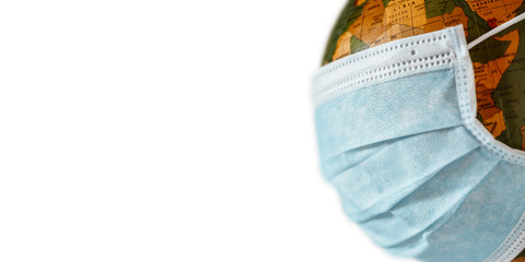 Isolated globe with face mask protection on white background. World medical concept.
