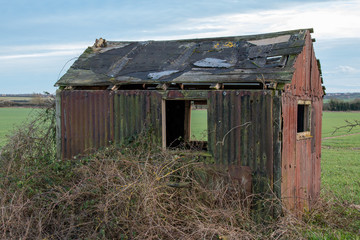 Abandoned falling down derelict shed