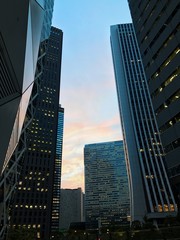 Fototapeta na wymiar modern business building with sunset, amazing view, beautiful scenery, cool landscape, sky tower in big city at evening, tokyo mode gakuen in nice weather