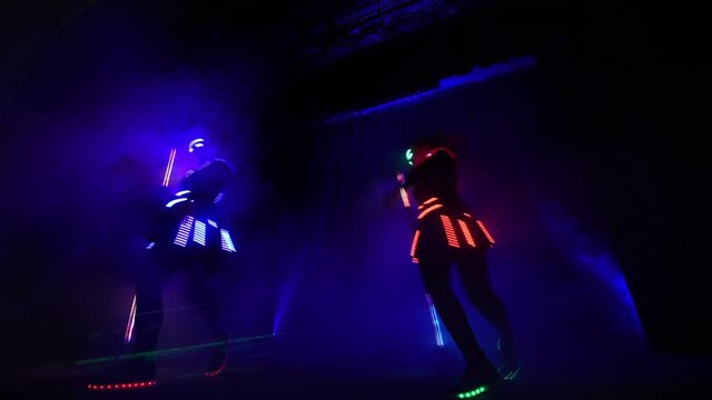Laser show performance, dancers in suits with LED lamp, very beautiful night club party.