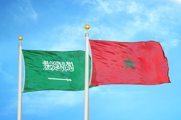 Saudi Arabia and Morocco two flags on flagpoles and blue cloudy sky