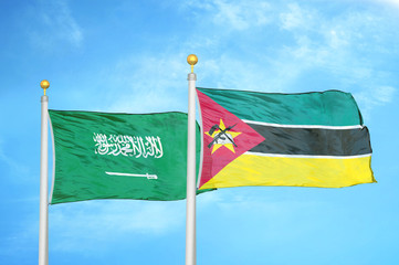 Saudi Arabia and Mozambique two flags on flagpoles and blue cloudy sky