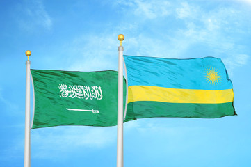 Saudi Arabia and Rwanda two flags on flagpoles and blue cloudy sky