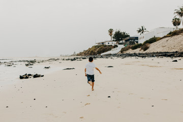 kid running on the beach