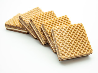 delicious hazelnut cream filled wafers on white background