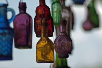 Colorful glass bottles suspended from a building