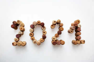 Wine corks 2021 composition isolated on white background from a high angle view