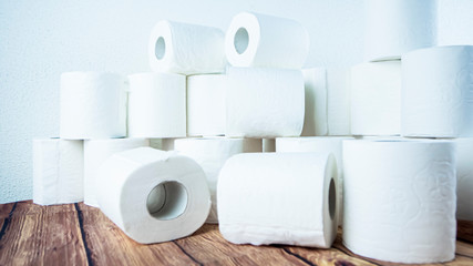 Lots of toilet paper rolls at home of hoarder amidst panic buying for corona virus outbreak shortage in Europe. Last stock of essential products for pandemic. Background photo of bath tissue rolls