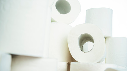 Lots of toilet paper rolls at home of hoarder amidst panic buying for corona virus outbreak shortage in Europe. Last stock of essential products for pandemic. Background photo of bath tissue rolls