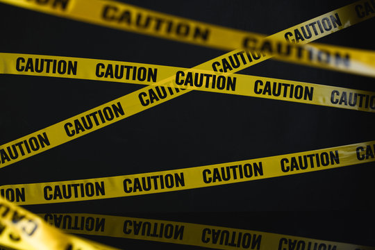caution yelow tape on black background