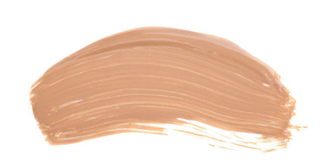 Close up of smeared cream nude color. Face skin concealer, make up base creamy texture on white isolated background with free copy space for text.
