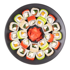 set of tasty rolls on a black plate for the restaurant menu on a white background