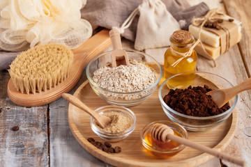Concept of home beauty care and natural organic ingredients in cosmetology. Coffee, honey, oil, oat for gentle skin peeling and moisturizing. Health care lifestyle. Wooden background closeup